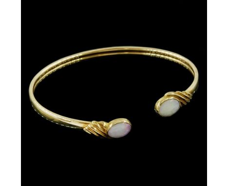 9ct gold opal torque bangle, London 1989Condition Report:Approx 6.35gm, inner circumference from end to end opal = 16.5cm, go