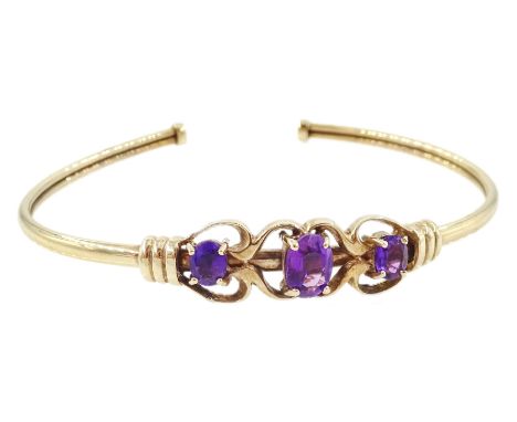 9ct gold three stone oval cut amethyst torque bangle, Birmingham 1992Condition Report:Approx 6.55gm, inner circumference end 