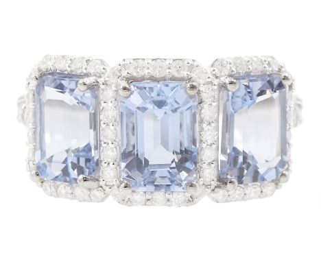 18ct white gold three stone emerald cut aquamarine and round brilliant cut diamond cluster ring, with diamond set shoulders, 