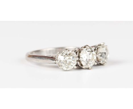 An 18ct white gold and diamond three stone ring, claw set with a row of old mine cut diamonds, weight 3.9g, total diamond wei