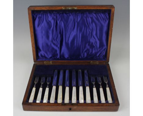 A set of six George V silver dessert knives and forks, each with mother-of-pearl handle, Sheffield 1924 by Levesley Brothers,