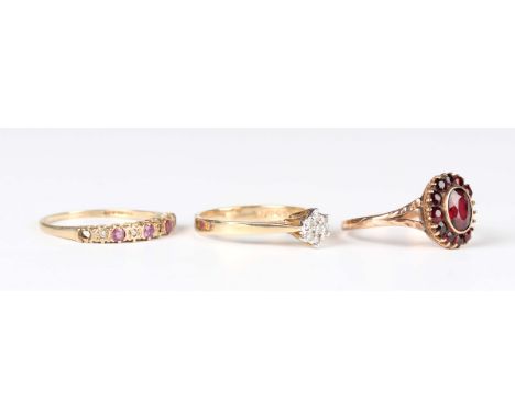 A 9ct gold and diamond seven stone cluster ring, London 1981, ring size approx N, a 9ct gold, ruby and diamond half hoop ring