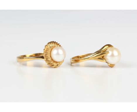 A gold ring, mounted with a cultured pearl between foliate shoulders, detailed '750', weight 4.4g, ring size approx P, and an