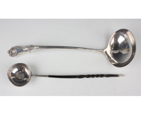 A George III silver toddy ladle, fitted with a twisted whalebone handle, the circular bowl inset with a coin and engraved to 