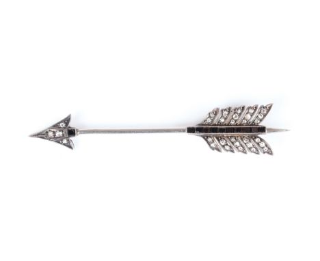 A gold backed and silver set, rose cut diamond and black onyx jabot pin, designed as an arrow, unmarked, weight 3.8g, width 6