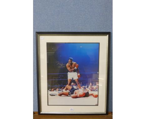 A Muhammed Ali photographic print, bearing signature, framed