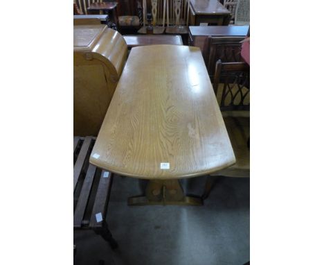 An Ercol style drop-leaf dining table
