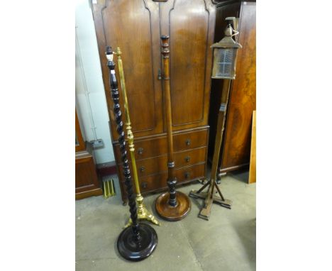 A brass standard lamp, a lantern style standard lamp and two mahogany standard lamps