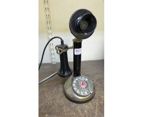A candlestick telephone