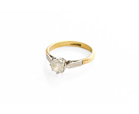 A Diamond Solitaire Ring, the round brilliant cut diamond in a white claw setting, to a yellow tapered shoulder plain polishe