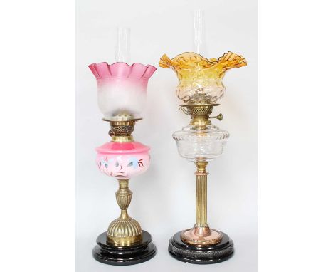 A Victorian Brass Based Oil Lamp, of fluted column form and with apricot blush shade, together with a similar (2)