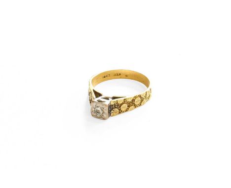 A Diamond Solitaire Ring, the round brilliant cut diamond in a white illusion setting, to a yellow textured band, finger size