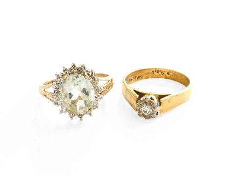 An Aquamarine and Diamond Cluster Ring, stamped '375', finger size L; and A Diamond Solitaire Ring, stamped '18CT', finger si