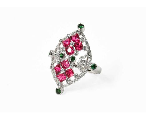 A Diamond, Synthetic Ruby and Green Garnet Cluster Ring, finger size LStamped '750'. Gross weight 8.0 grams.