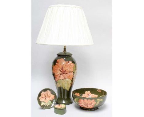 A Walter Moorcroft Coral Hibiscus Pattern Lamp, on green ground, impressed marks, 33cm high (excluding fitments) and three ot