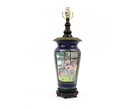 A Canton Enamel Vase, 19th century, painted in famille rose enemals with figures in gardens on a blue ground decorated with f