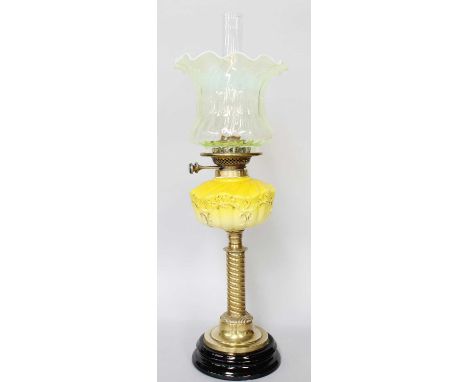 A Victorian Brass Based Oil Lamp, with Vaseline glass shade and opaque yellow glass reservoir