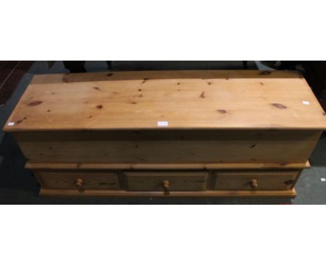 A modern pine mule chest with three inline drawers to base and lift up trunk