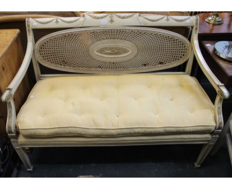 A cream and gilt framed bergere backed two seater salon style sofa