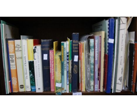 A shelf of paper and hard books relating to Warwickshire
