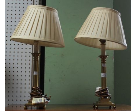A pair of modern Laura Ashley branded brass effect stick table lamps