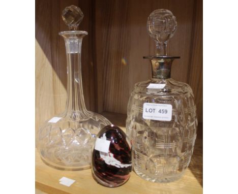 A cut glass spirit decanter, with hallmarked silver collar, and original stopper, with one other decanter and a glass paperwe