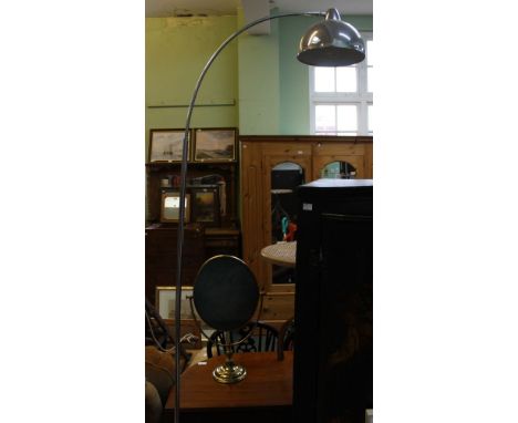 A modern chrome finished floor standing reading lamp.