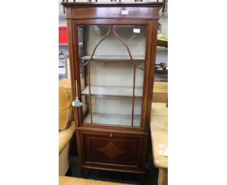 An early 20th century glazed three shelf display cabinet with magazine slide to base Condition: The tops scratched / scuffed,