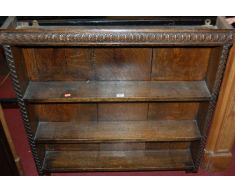 An early 20th century moulded oak three tier wall shelf