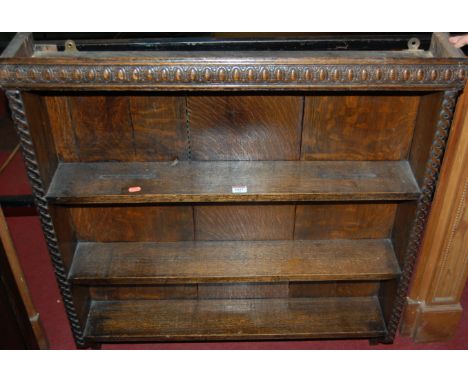 An early 20th century moulded oak three tier wall shelf