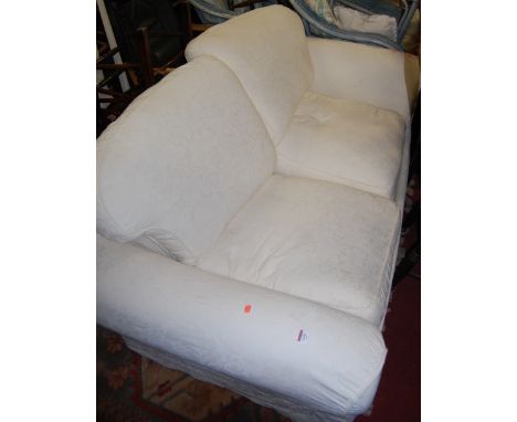 A modern white floral upholstered three-seater sofa
