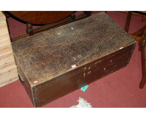 A stained wood hinged top tool chest with end carry handles