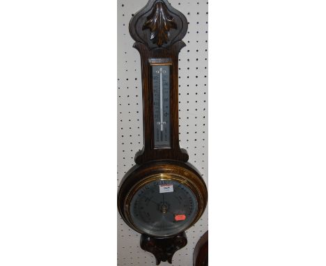A 20th century oak line carved two-dial aneroid barometer