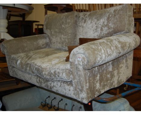 A modern upholstered two seater sofa on outswept supports, together with a floral upholstered three seater sofa (2)