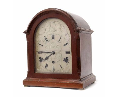 Mahogany arch top three train mantel clock signed on the silvered foliate engraved dial J.W Benson, 11" high (pendulum and wi
