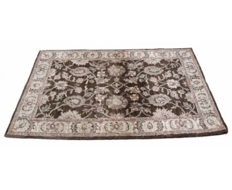 Indian Jaipur Ushak design wool pile carpet, with repeated foliate motif on a brown ground, 86" x 47" approx