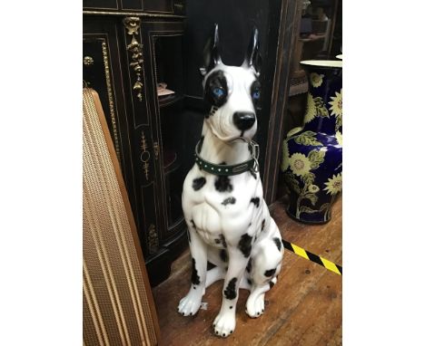 A large ceramic figure of a black and white Great Dane with blue eyes, approx. 90cm high. Together with a Royal Doulton porce