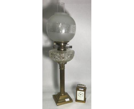 A Victorian oil lamp, with brass classical column supporting a cut glass reservoir, etched glass globular shade, 72cm high, t