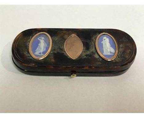 An 18th century tortoiseshell patch box, with inlaid gold mounted Wedgwood cameos and a central unengraved gold cartouche, 9c