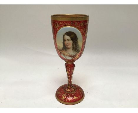 A 19th century Bohemian cranberry glass goblet, decorated with a hand-painted oval portrait of a young girl and with scrollin