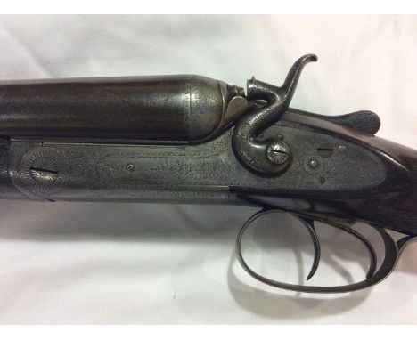 A Holland &amp; Holland 12-bore hammer action shotgun, with 28" inch side-by-side Damascus barrels, finely foliate-engraved l