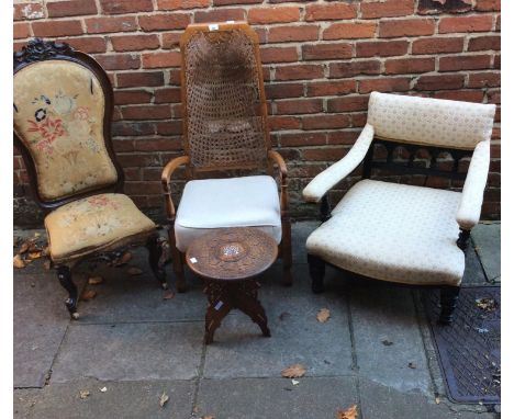 A Victorian nursing chair with floral tapestry upholstery, together with a low armchair, a carver with caned back and a flora