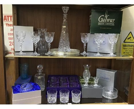 Two shelves of cut glass including a cut glass decanter of tapering hexagonal form, Waterford Crystal squat candlesticks, set