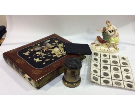 A brass photographic 50mm iris lens by Emil Busch, 'Rapid Aplanat Number 5 Foc. 18ins' and a Royal Dux ceramic figure-group o