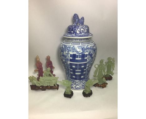 A large Oriental blue and white temple jar and cover with Dog of Fo finial, 49cm high, together with some jade coloured figur