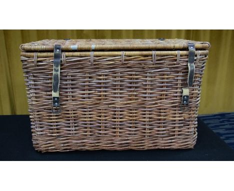 An oversized wicker basket/hamper of rectangular form, with leather strap locks and handle to either side, 88cm 