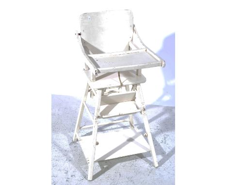 White painted folding child's high chair, with hinged tray, splayed legs joined by a shelf, width approximately 42cm, height 