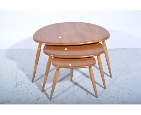 Nest of three Ercol light elm and beech coffee tables, each with a shaped oval top and turned splayed legs, largest 66cm x 45