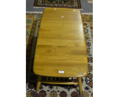 An Ercol elm and beech coffee table, rectangular top with rounded corners, splayed legs joined by rails, the top 105 x 47cm, 