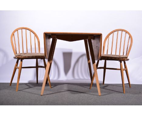 Ercol light elm and beech dining suite comprising a table, rectangular rounded top with two fall leaves, splayed legs, the ta